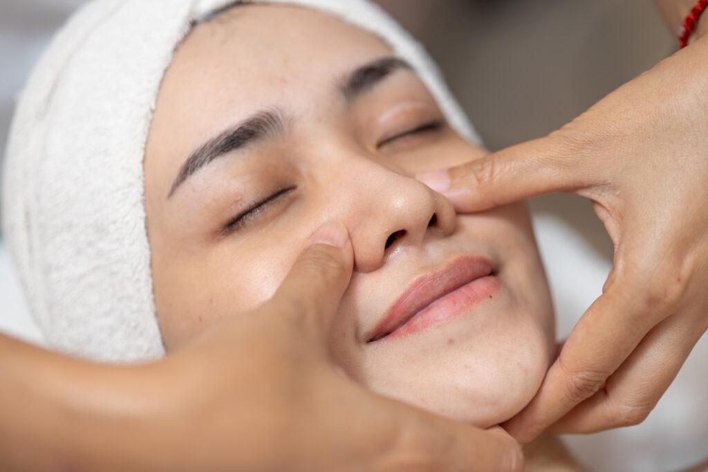 Beauty women facial hand finger press massage in spa, Face skin treatment body care relax claim with skincare baby face at wellness.